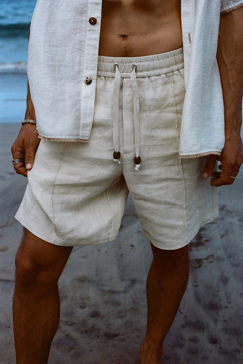Close-up of man wearing our sand linen Easy Going Shorts with our featherweight Resort Shirt on top.