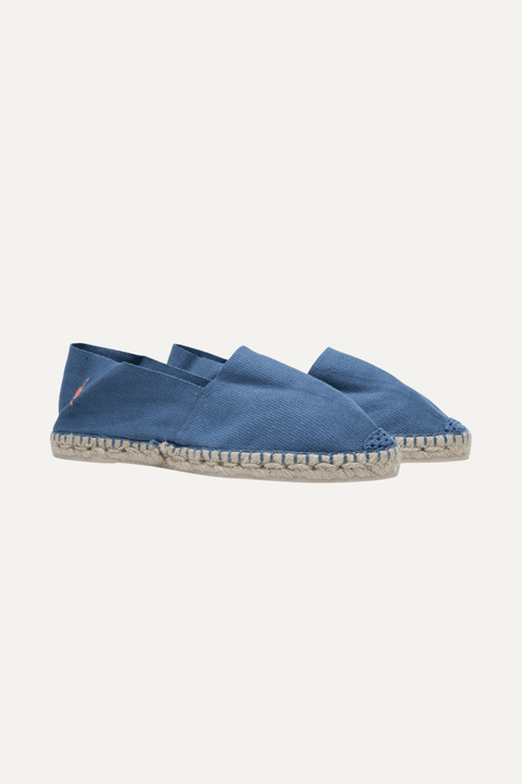 A single blue canvas espadrille slip-on shoe with a braided jute sole and a small pink flamingo logo on the side, shown against a light off-white background - Inkerman NYC