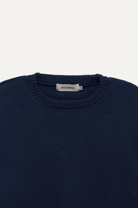Close-up of a navy blue ribbed knit sweater - Inkerman NYC