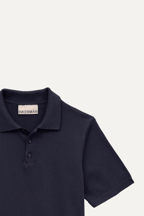 Close-up of a navy blue short-sleeve polo shirt with a three-button placket - Inkerman NYC