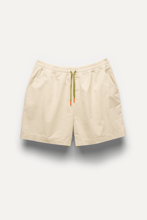 Beige drawstring shorts with an elastic waistband, displayed flat against a light off-white background - Inkerman NYC