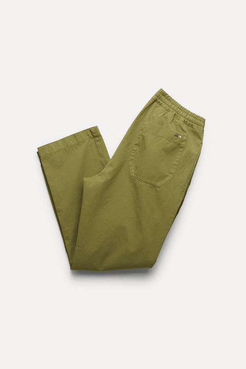 A pair of olive green trousers folded neatly on a light off-white background - Inkerman NYC