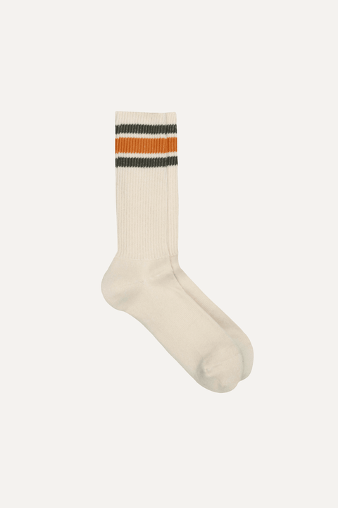 A single off-white ribbed crew sock with two horizontal stripes near the cuff, one orange and one grey, shown on a plain light background - Inkerman NYC
