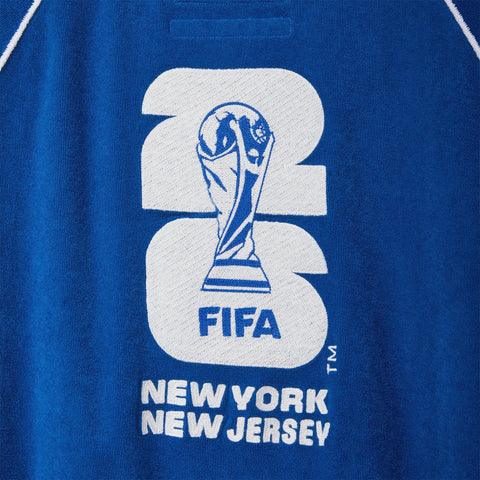 Close-up of a blue terry polo with a large FIFA World Cup 26™ New York New Jersey graphic on the back.