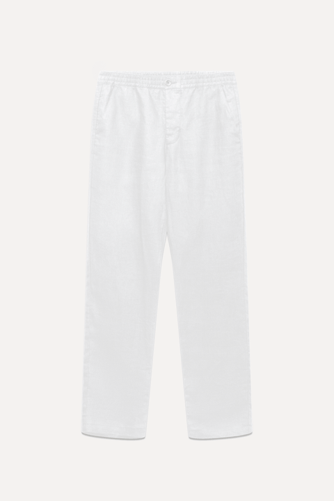 White linen pants with an elastic waistband, shown flat against a light off-white background - Inkerman NYC